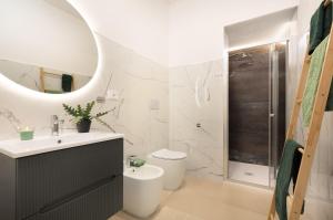 a bathroom with a sink and a toilet and a shower at Sve Suites Cagliari in Cagliari
