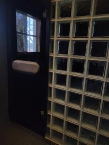 a glass block wall with a door and a window at Villa Onnela Ämttöö in Pori +34 photos