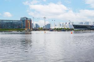 a large body of water with a city in the background at Heads on Bed- London Excel Royal Victoria Dock O2 in London
