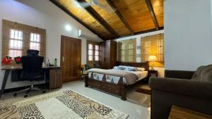 a bedroom with a bed and a desk and a couch at A Luxury Duplex in Dili City, Timor-Leste in Dili