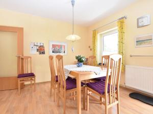 a dining room with a table and chairs at Cozy Apartment in Rerik near the beach in Rerik