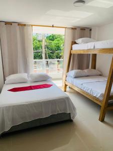 two bunk beds in a room with a window at Hotel Belmar piso 2 in Cartagena de Indias