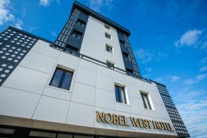 a building with the words noel west house on it at Nobel West Hotel in Belgrade