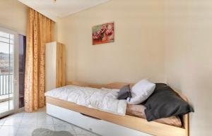 a bedroom with a bed with white sheets and pillows at Nikol apartment in Thessaloniki