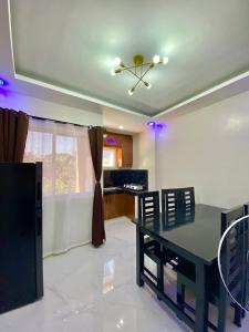 a living room with a dining table and a kitchen at Second Pad at Second floor in Bolinao +16 photos