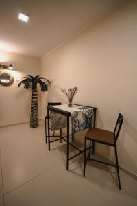 una mesa y una silla en una habitación con una planta en Vinto House Salerno Downtown en Salerno