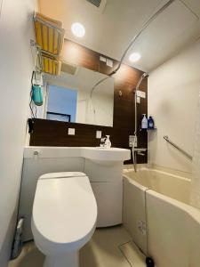 a bathroom with a toilet and a sink and a tub at home shinjuku west301 in Tokyo