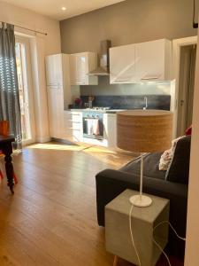 a living room with a couch and a kitchen at Agrigento Flat - apartment with Private Parking in Agrigento