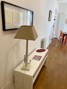 a lamp on a white table in a living room at Agrigento Flat - apartment with Private Parking in Agrigento