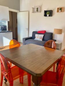 a living room with a table and a couch at Agrigento Flat - apartment with Private Parking in Agrigento