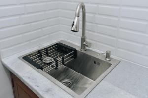 a stainless steel sink with a faucet in a kitchen at Padma Amita Yogyakarta in Jetis