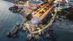 an aerial view of a resort near the ocean at Renovated apartment on beachside with pool in Nerja