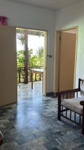 um quarto com uma porta, um banco e uma mesa em Villa Sabang Beach Resort em Puerto Galera