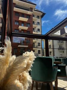 a view from a balcony with chairs and a building at All Seasons Residence in Zlatibor
