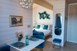 a hotel room with a bed and a table and chairs at NOTRE CHALET - Boutique Hôtel - En couple - En famille - En groupe in Les Fourgs