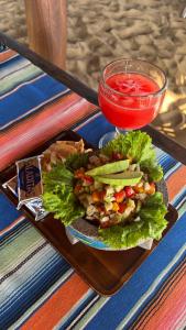 a plate of food with a salad and a drink at CAFE MAYA in Zipolite +25 photos