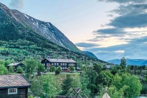 a house on a hill next to a mountain at New appartment in Lom inkl bedding in Lom
