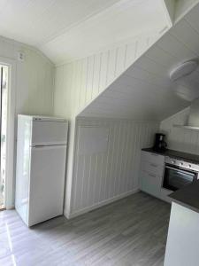 a kitchen with a white refrigerator in a room at New appartment in Lom inkl bedding in Lom