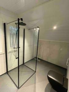 a glass shower in a room with a toilet at New appartment in Lom inkl bedding in Lom