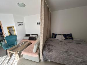 a bedroom with a bed and a table and a couch at Apartment Nadja in Budva