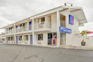a white building with a welcome sign on it at Motel 6-Portland, OR - Central in Portland