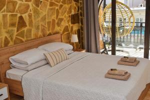 a bedroom with a bed with towels on it at Κρητικό παραδοσιακό διαμέρισμα! in Chania Town +13 photos