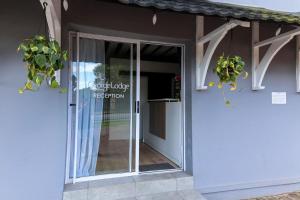 an entrance to a building with a glass door at George Lodge International in George