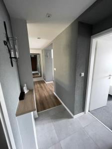 an empty room with a hallway with a door at Gray&Wood in Prievidza
