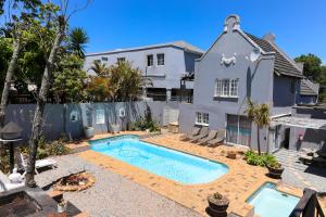 a swimming pool in the backyard of a house at George Lodge International in George