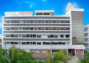a white building with a sign on top of it at Hotel Tri Sea in Kanyakumari