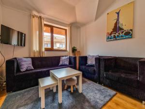 a living room with two couches and a table at Cedar Lodge 2 Bedroom Apartment by Flat Mаnager in Bansko