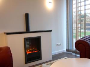 a living room with a fireplace with a fire at Chalet Wendorf in Wendorf