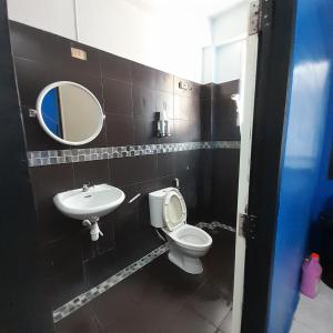 a bathroom with a sink and a toilet and a mirror at DK1Hostel in Chaweng