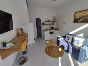 a living room with a blue couch and a table at Huisje Louis in Zandvoort +7 photos
