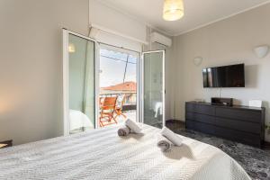a bedroom with a bed with two towels on it at Sunset Serenity - Kardamili Seaside Getaway in Kardamili