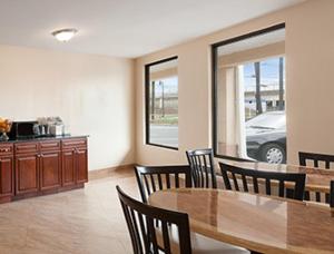 a dining room with a table and chairs and a car at Super 8 by Wyndham Rahway/Newark in Rahway