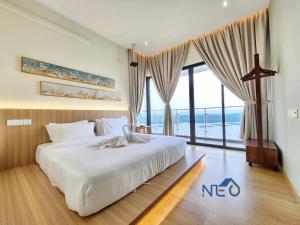 a bedroom with a large bed and a large window at Country Garden Danga Bay InStyle Sea View Homestay Suite by NEO in Johor Bahru