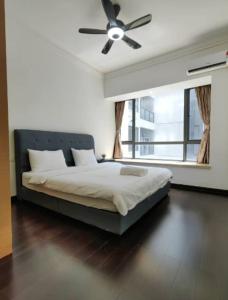 a bedroom with a bed with a ceiling fan at Sofia Superior Suite 2R2B-51902 at R&F Princess Cove in Johor Bahru