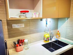 a kitchen with a sink and a counter top at Sofia Superior Suite 2R2B-51902 at R&F Princess Cove in Johor Bahru