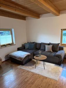 a living room with a couch and a table at Blockhaus im Bayrischen Wald in Hohenau