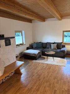 a living room with a couch and a fireplace at Blockhaus im Bayrischen Wald in Hohenau +7 photos