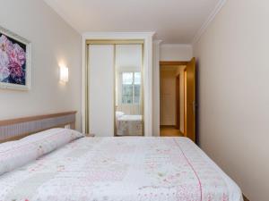 a bedroom with a large bed and a mirror at Bonanza 5 - Apartment In Colònia De Sant Jordi Free Wifi in Colònia de Sant Jordi