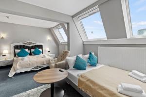 Łóżko lub łóżka w pokoju w obiekcie Hotel George Vienna