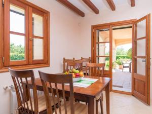 a dining room with a wooden table and chairs at Can Bielet - Villa With Private Pool In Binissalem Free Wifi in Lloseta
