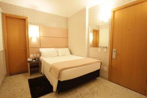 Postel nebo postele na pokoji v ubytování Hotel Confiance Centro Cívico