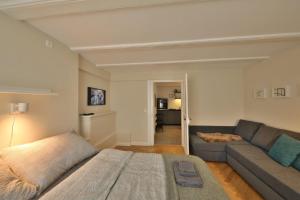 a living room with a bed and a couch at Union Apartments Bern-Belp in Belp