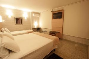 Postel nebo postele na pokoji v ubytování Hotel Confiance Centro Cívico