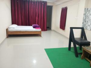 Pokój z łóżkiem i czerwoną zasłoną w obiekcie ALPHA Hotel w mieście Imphal