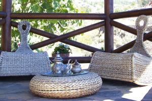 two wicker chairs and a table on a porch at holiday home Caserio Lomo Arriba Torre del Sol Vera de Erques in Vera de Erque