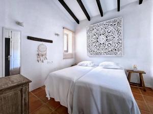 a bedroom with a white bed in a room at Spacious Retreat with Games in Benissa +32 photos